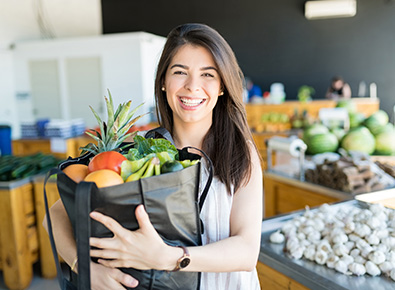 woman holding a bag of groceries 